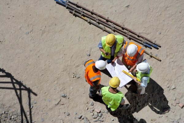 Contractor reviewing WCB and payroll requirements with financial documents in Canada