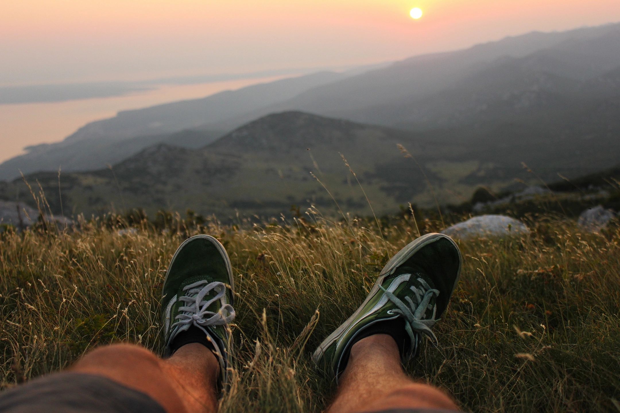 Person watching sunset stress-free knowing they are living their authentic life not having to worry about taxes.